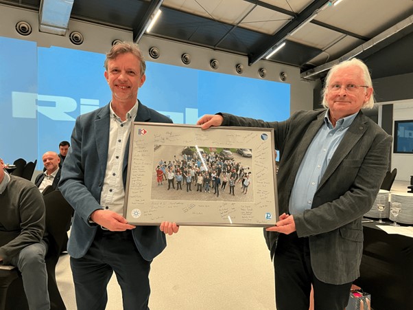 Adrian Jones presenting Damian with a retirement gift of a signed group photo of the Rigaku Polska Team.