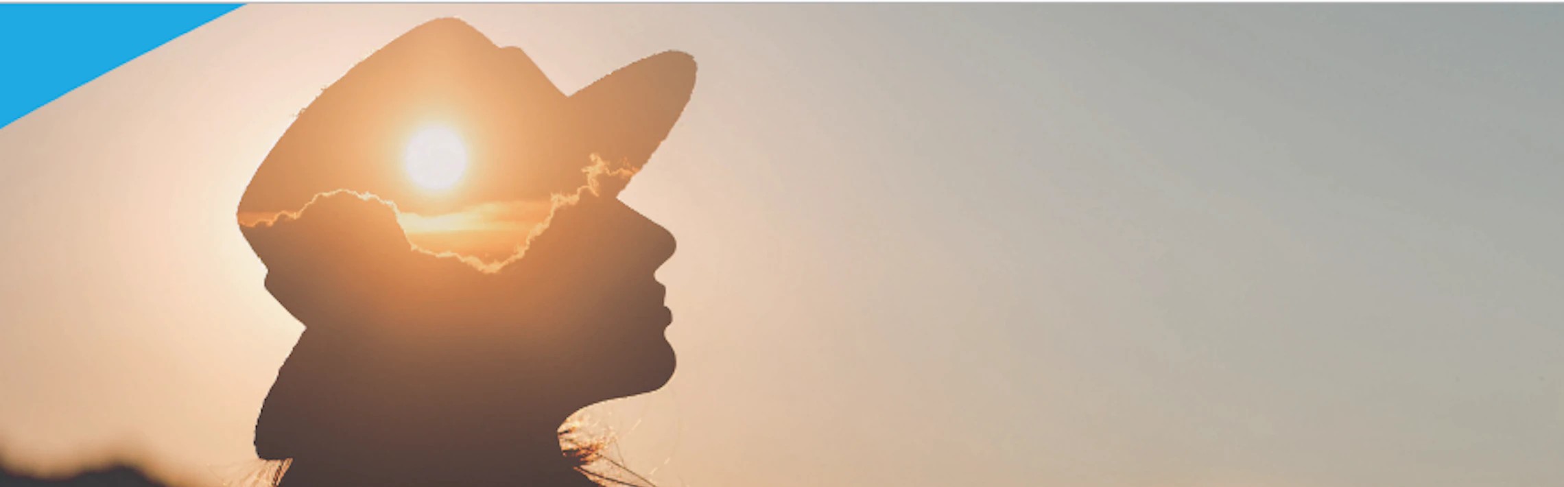 Double exposure image with silhouette of a woman wearing a hat and a sunset. 