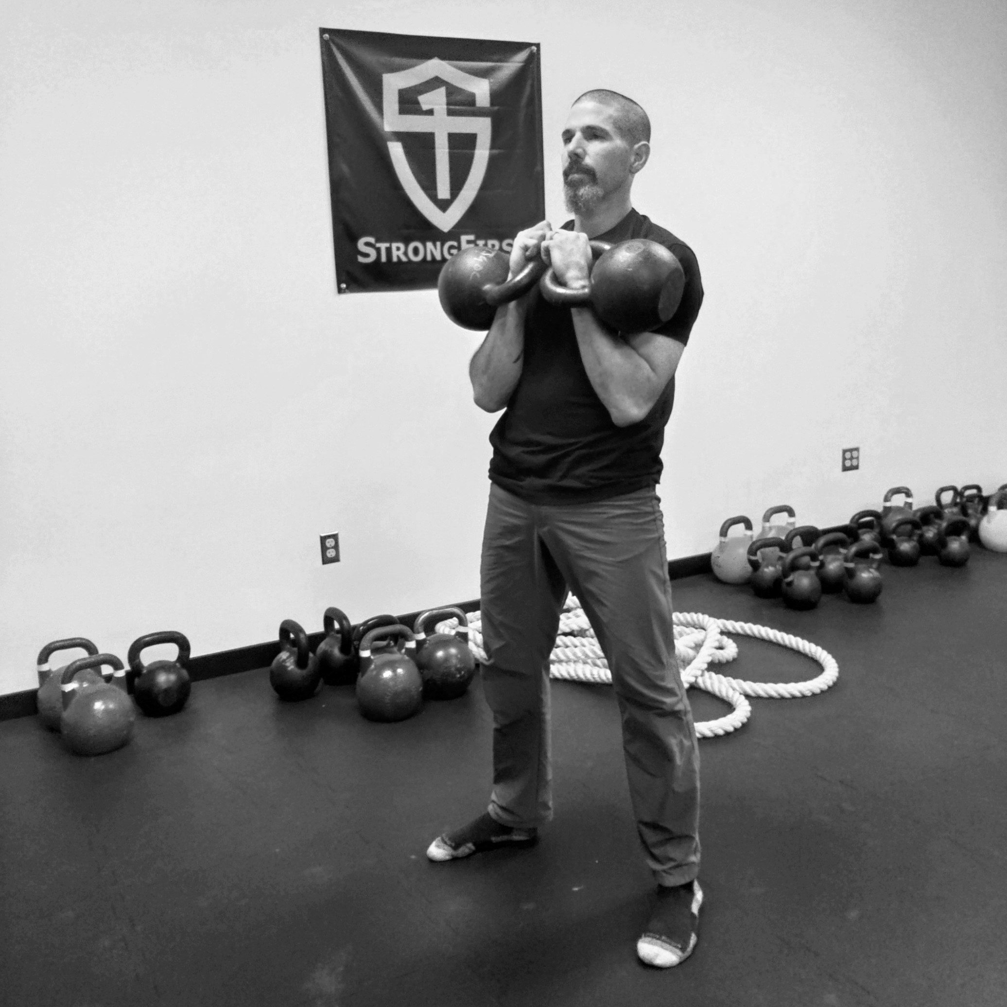 John Heinz showing the double kettlebell rack position