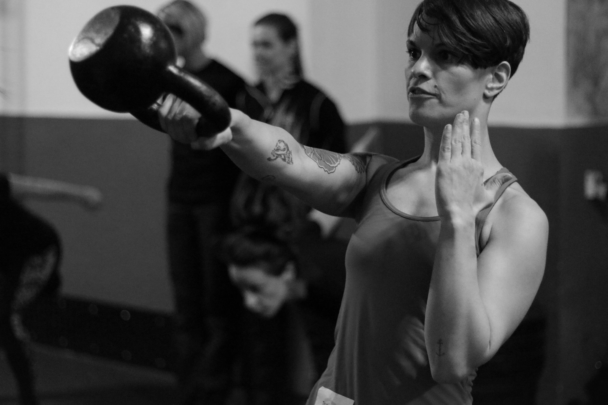 A student performing the one-arm kettlebell swing