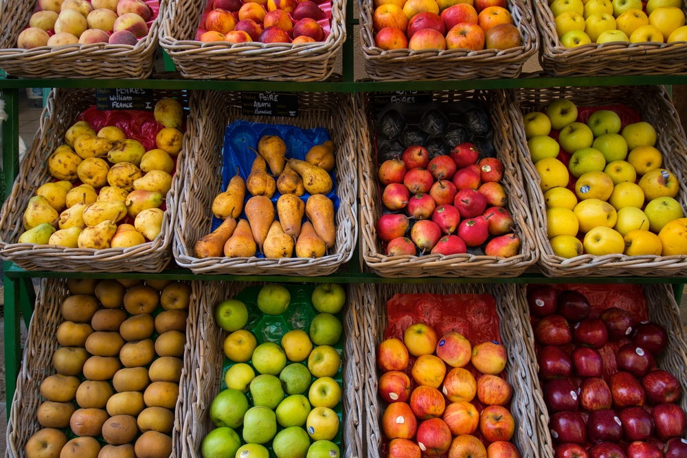 Fruits in baskets on market place.