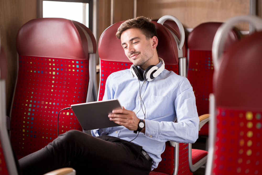 Photo of modern commuter relaxing on train. 