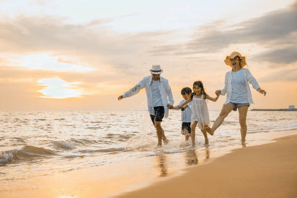 Family having fun on a beach at sunset