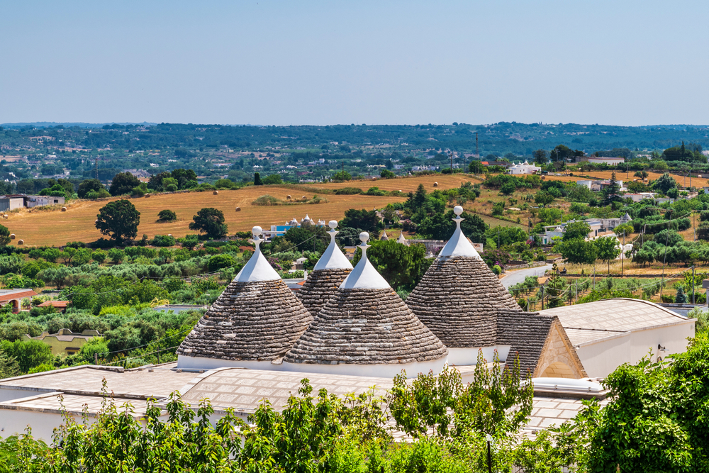 A mother and child running in the seashore with sunset in background