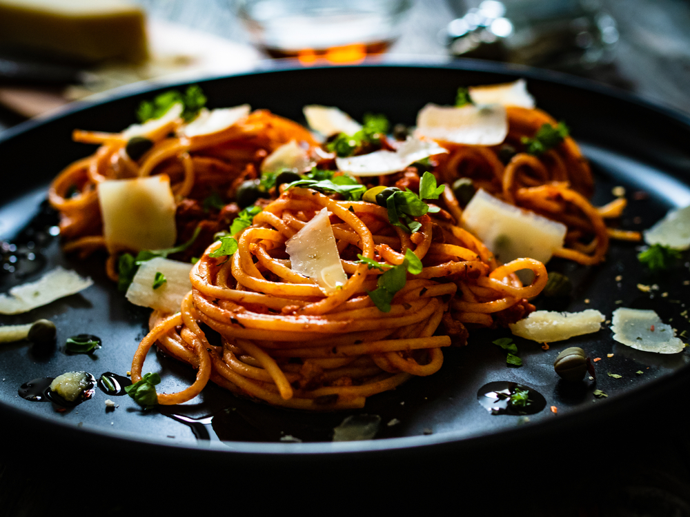 bowl of pasta on black platter 