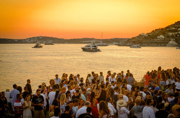 Gathering of people in Santorini, Greece outside at sunset 