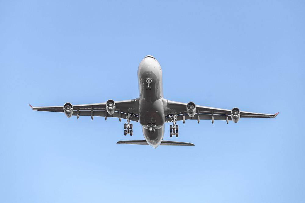 Airplane taking off in blue sky background 