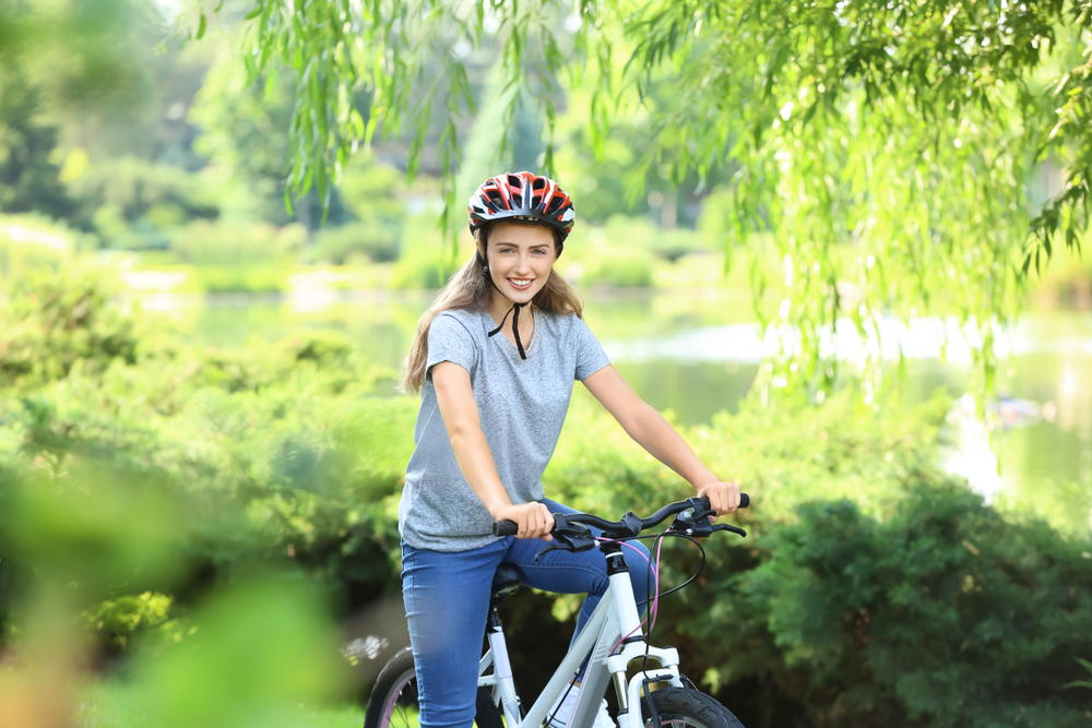 Young woman riding bicycle in Italy