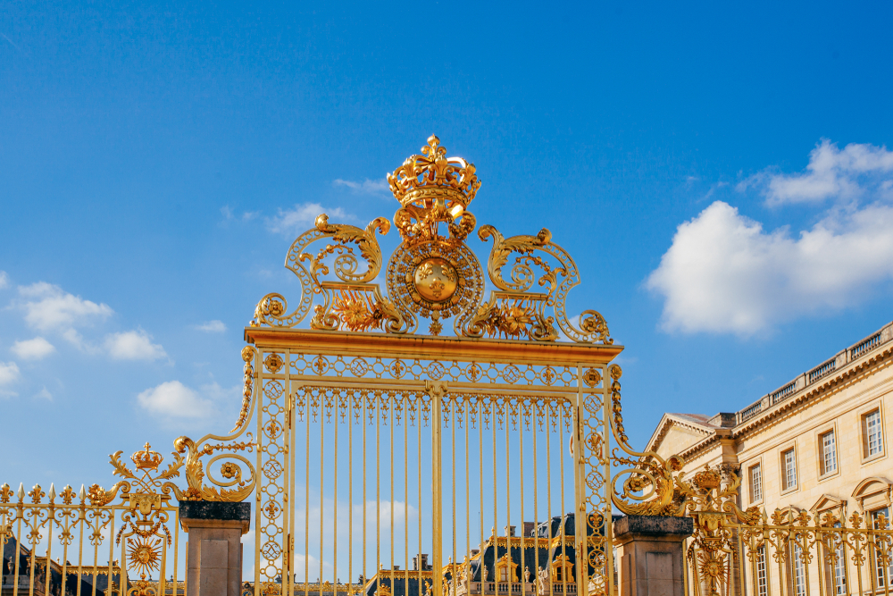 Versailles chateau. France. View of golden gate to palace. Royal residence near Paris. King's quarters. 