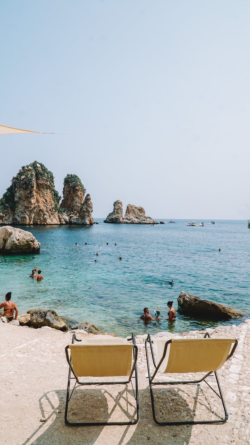 Loungers on a Rocky Beach in Scopello, Sicily 