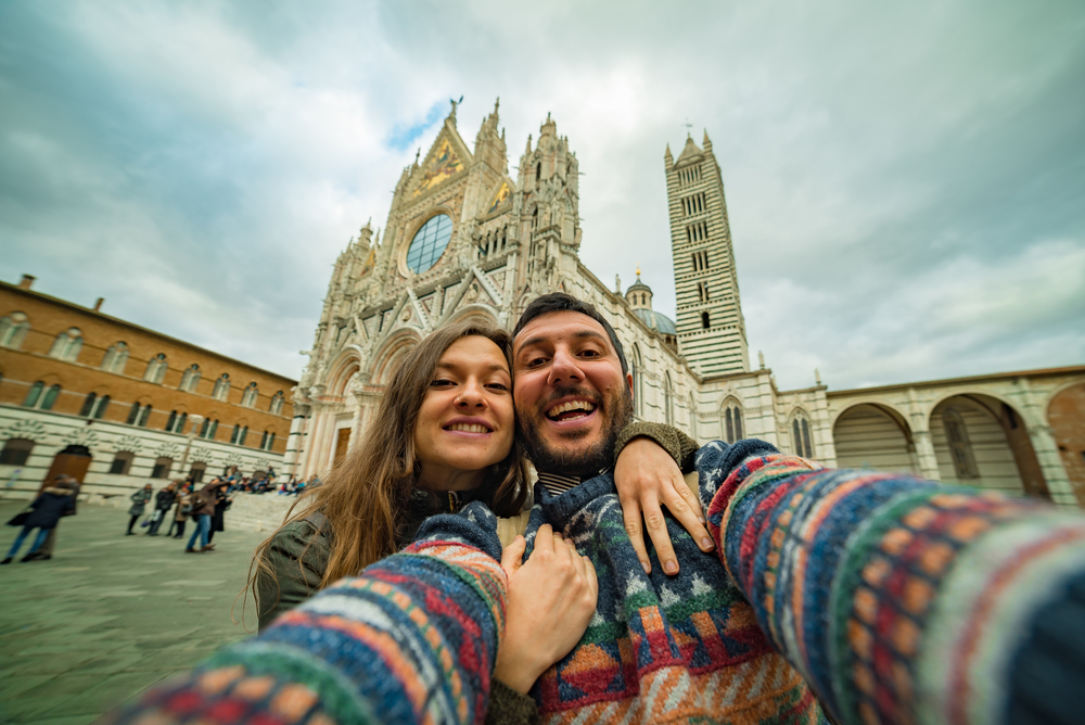 Tourists take photo selfie in the city of siena Siena, a beautiful medieval town in Tuscany, Italy.