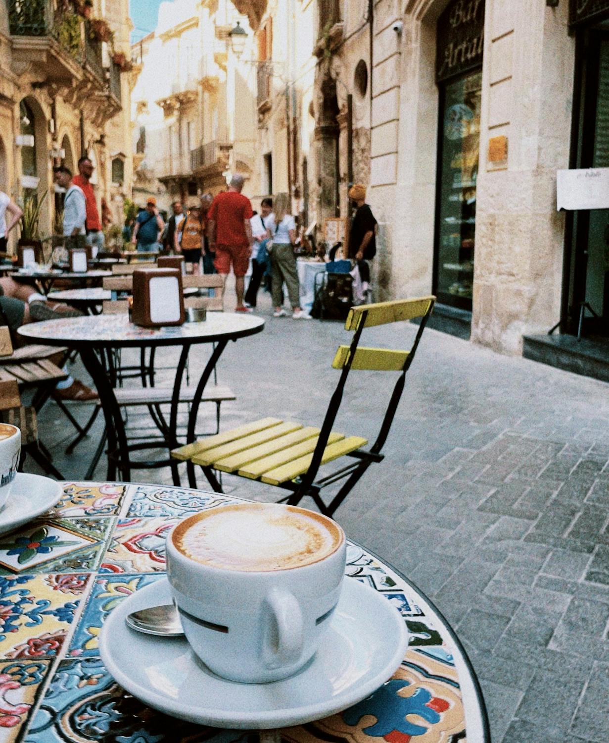 Pasta with meat, tomato sauce and vegetables on wooden table.