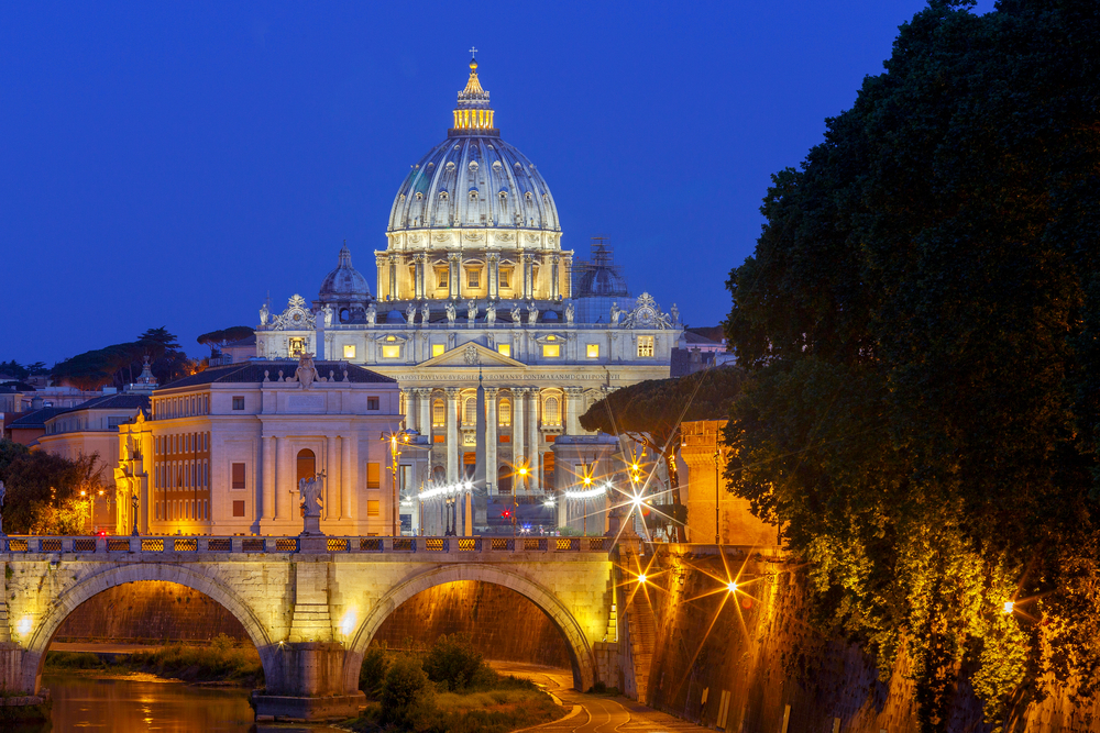 Night view of the Tiber River and St. Peter's Cathedral in the Vatican. Italy.