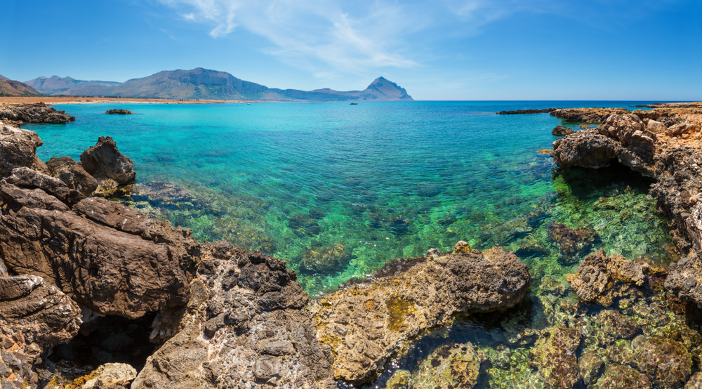 Azure Tyrrhenian sea picturesque rocky bay, Monte Cofano mount and Santa Margherita Beach view, Macari, San Vito Lo Capo region,