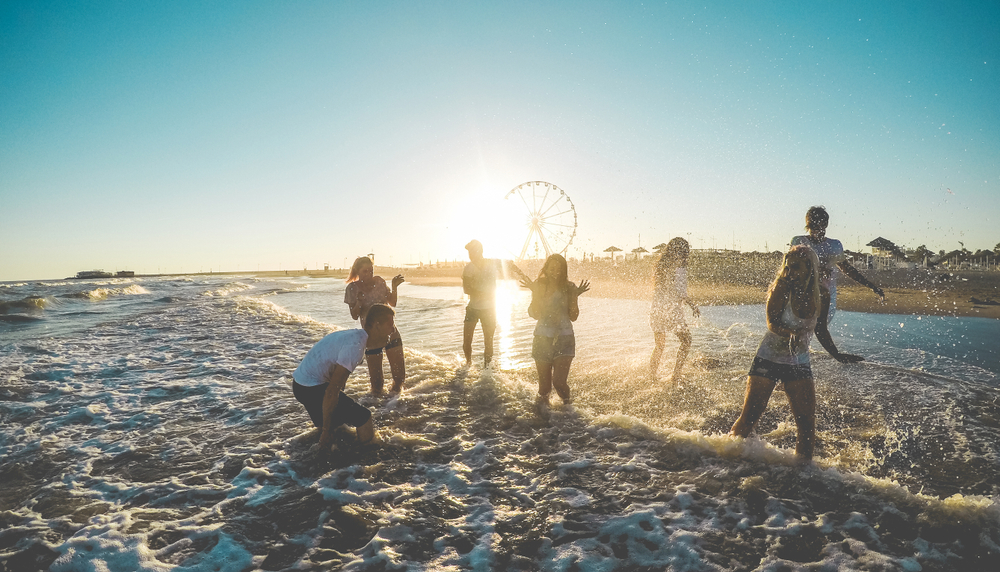 White Concrete House Near Body of Water Under White and Blue Cloudy Sky In Santorini