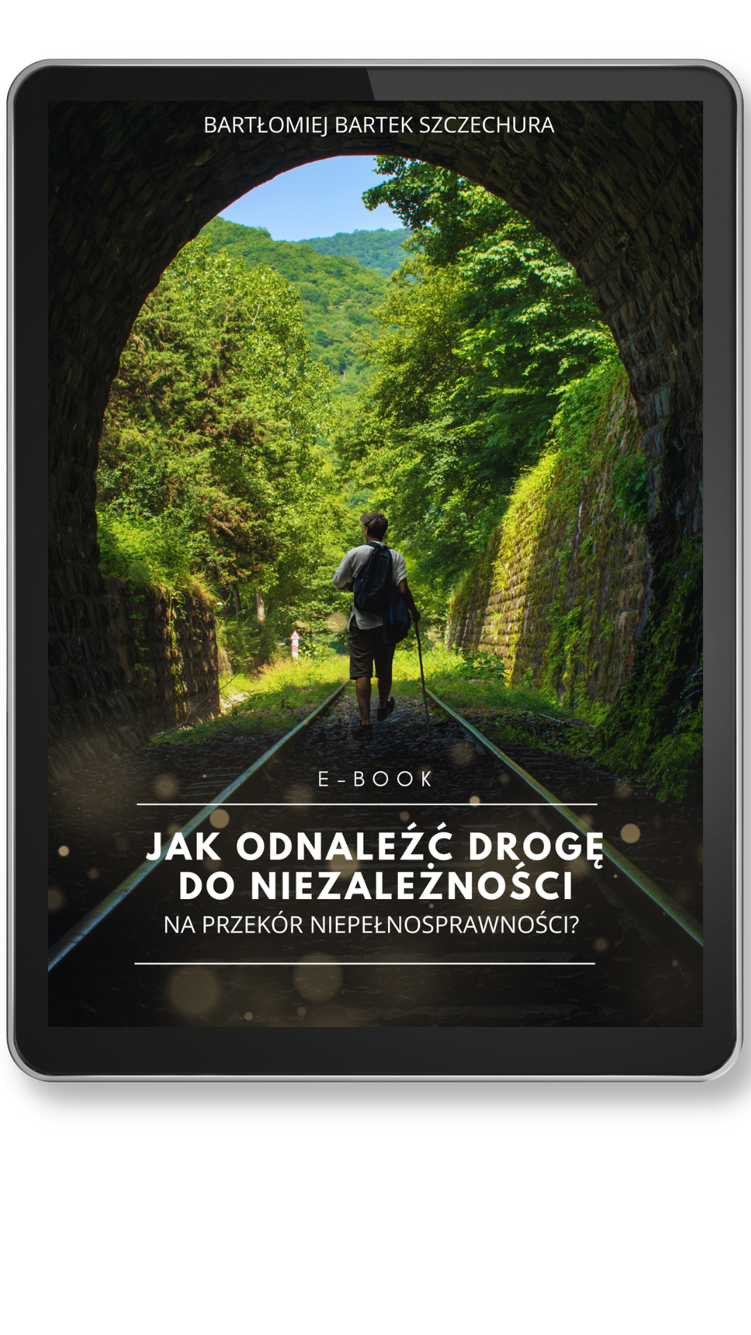 Okładka e-booka wyświetlona na ekranie tabletu. Na zdjęciu w tle widać mężczyznę z plecakiem i laską, który idzie środkiem torów kolejowych prowadzących przez kamienny tunel w stronę gęstego lasu. Autor: Bartek Bartłomiej Szczechura.
