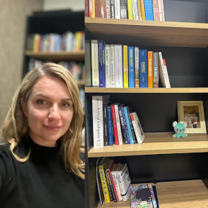 A photo of list author (Anna Broughel) and her bookshelf