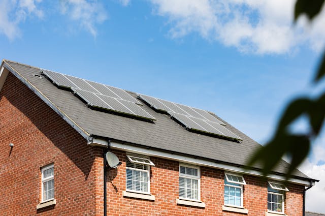 A photo of solar panels on the roof of a house