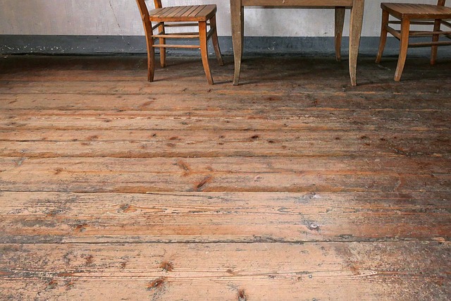 A photo of a wooden table and chairs on top of wooden floorboards