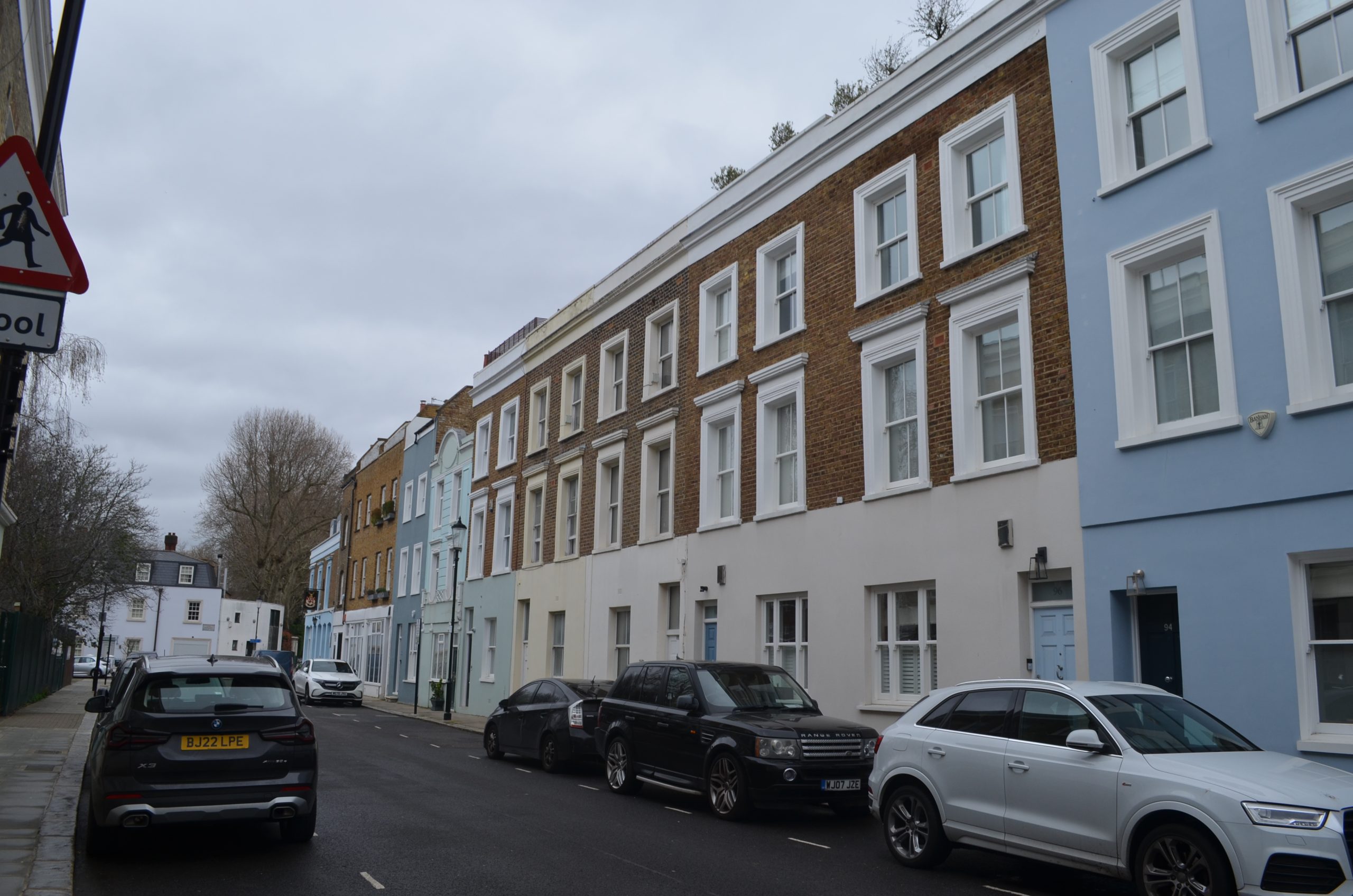 A photo of a street of large terraced houses which have been retrofitted