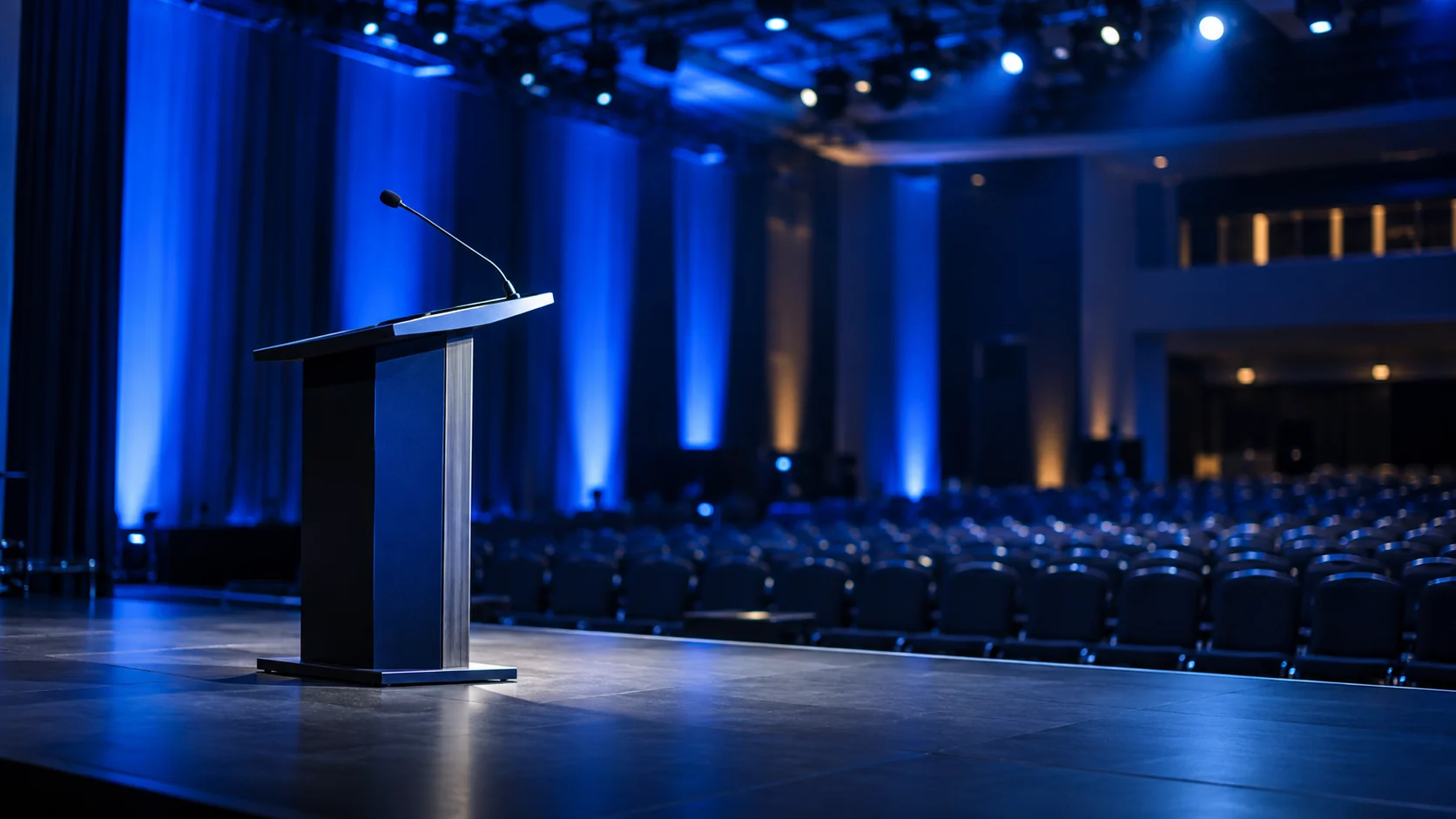 Escenario preparado para una conferencia con iluminación azul.