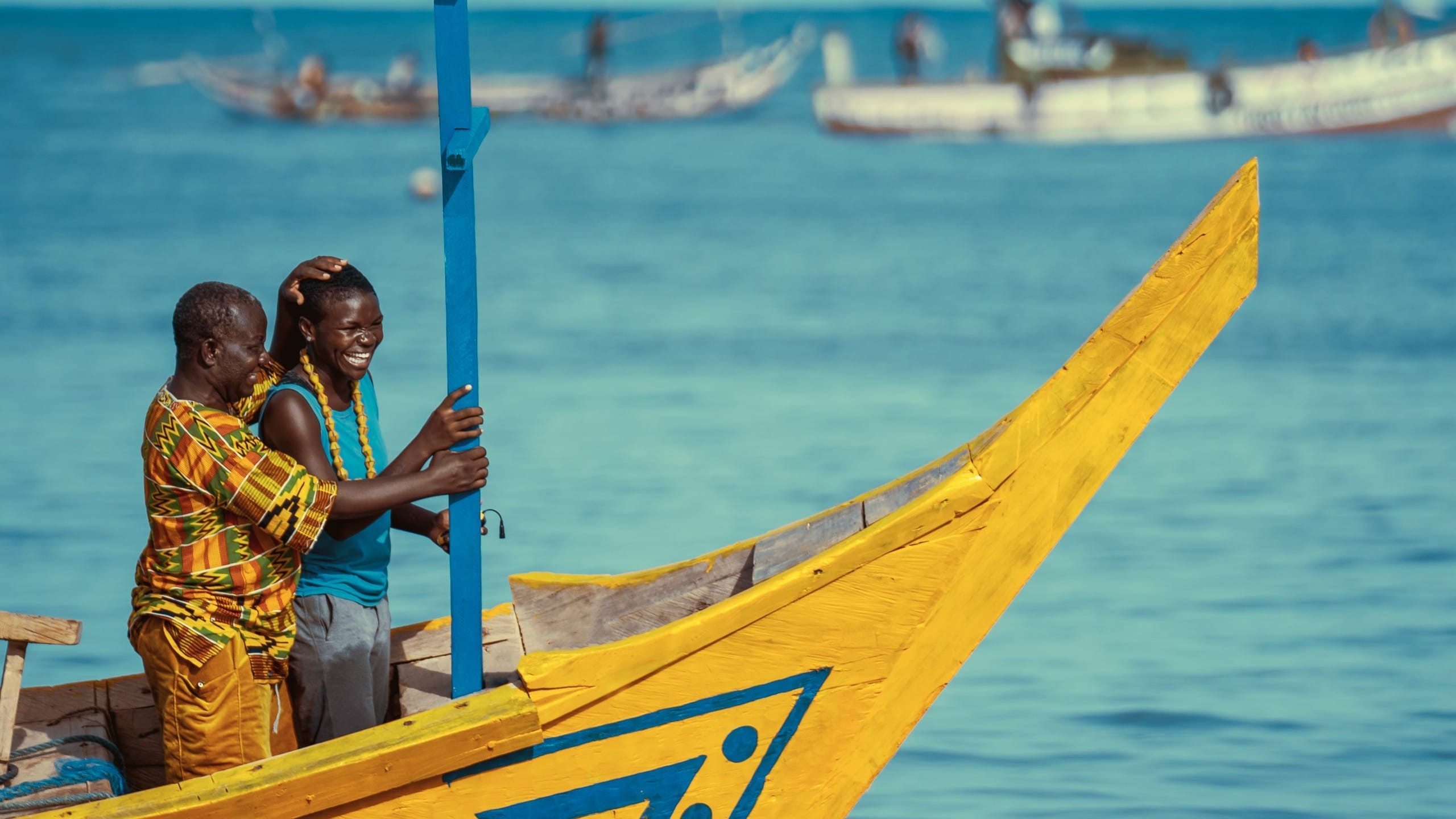 2 men on a brightly coloured boat