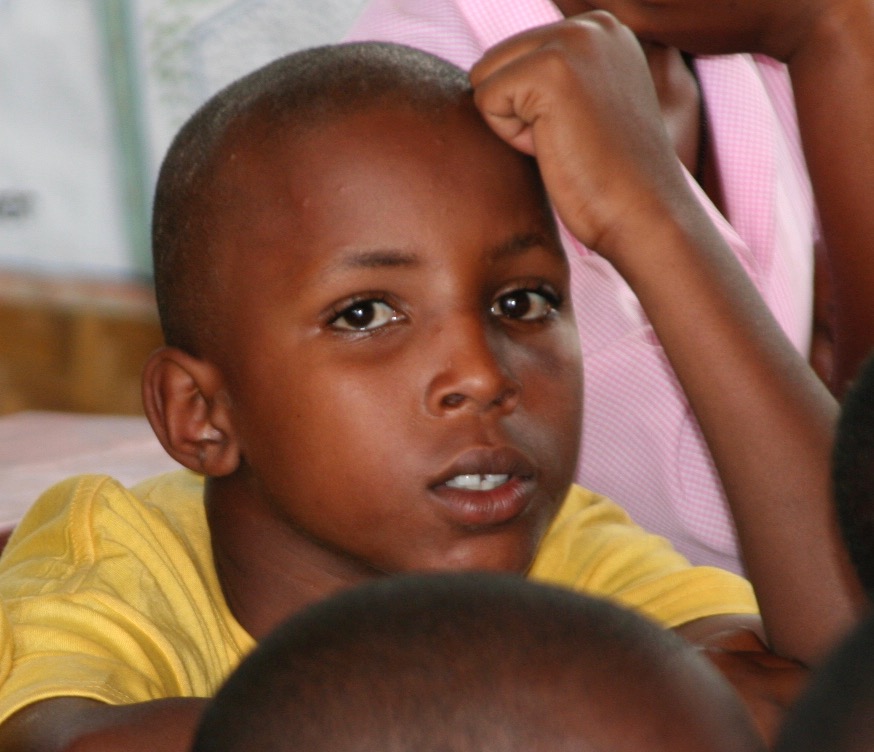 Nine-year-old Ugandan boy looking thoughtful