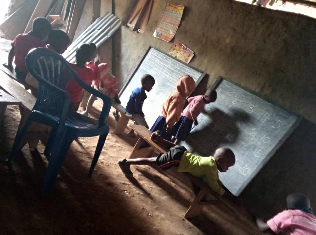 Dark, disorganized, makeshift school in Uganda