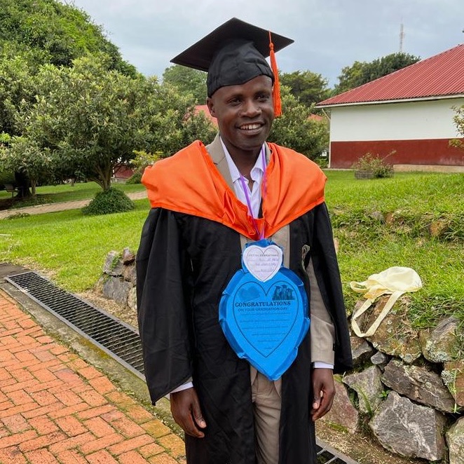 Young Ugandan man in a graduation cap and gown