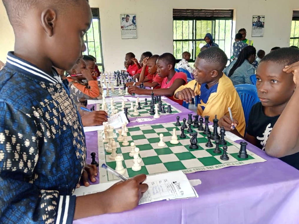 Uganan children of many ages playing chess