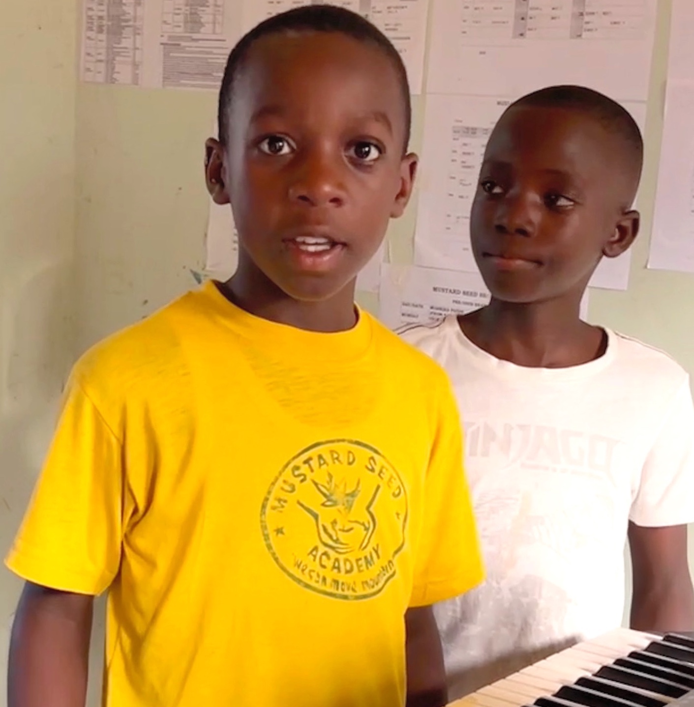 Two young Ugandan students with keyboard