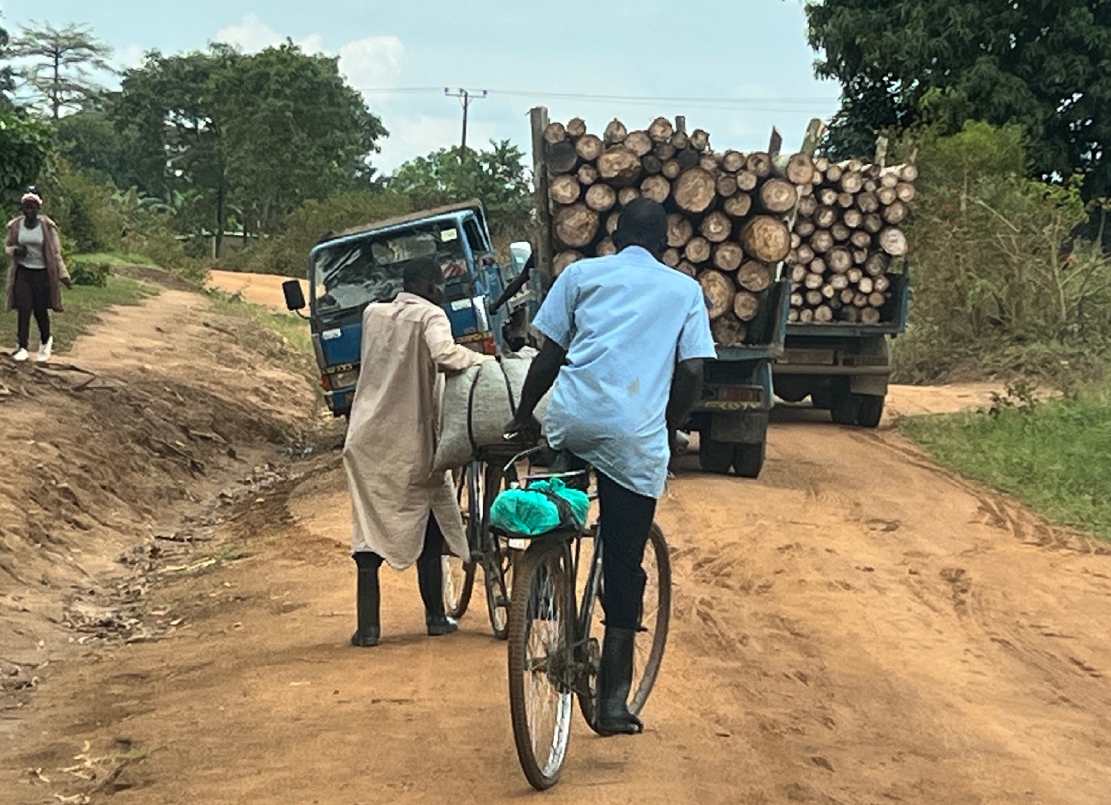 Many smiling young and older Ugandan students on a bus