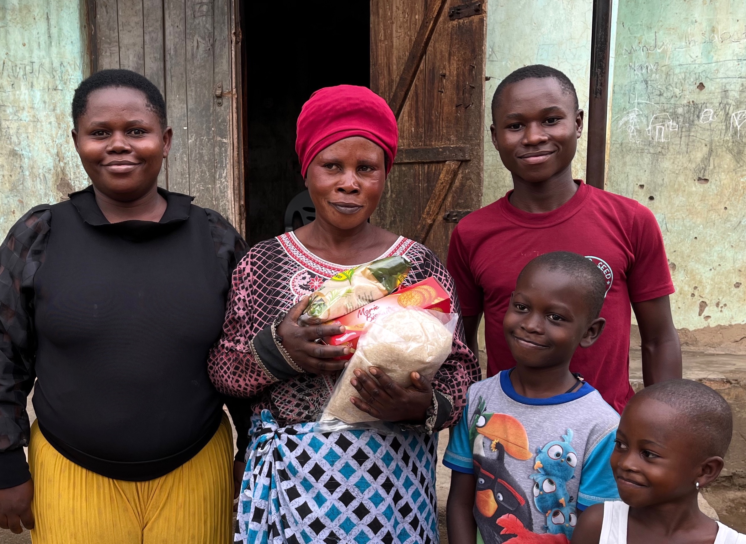 Mustard Seed children with food bag, soap, and chicken 