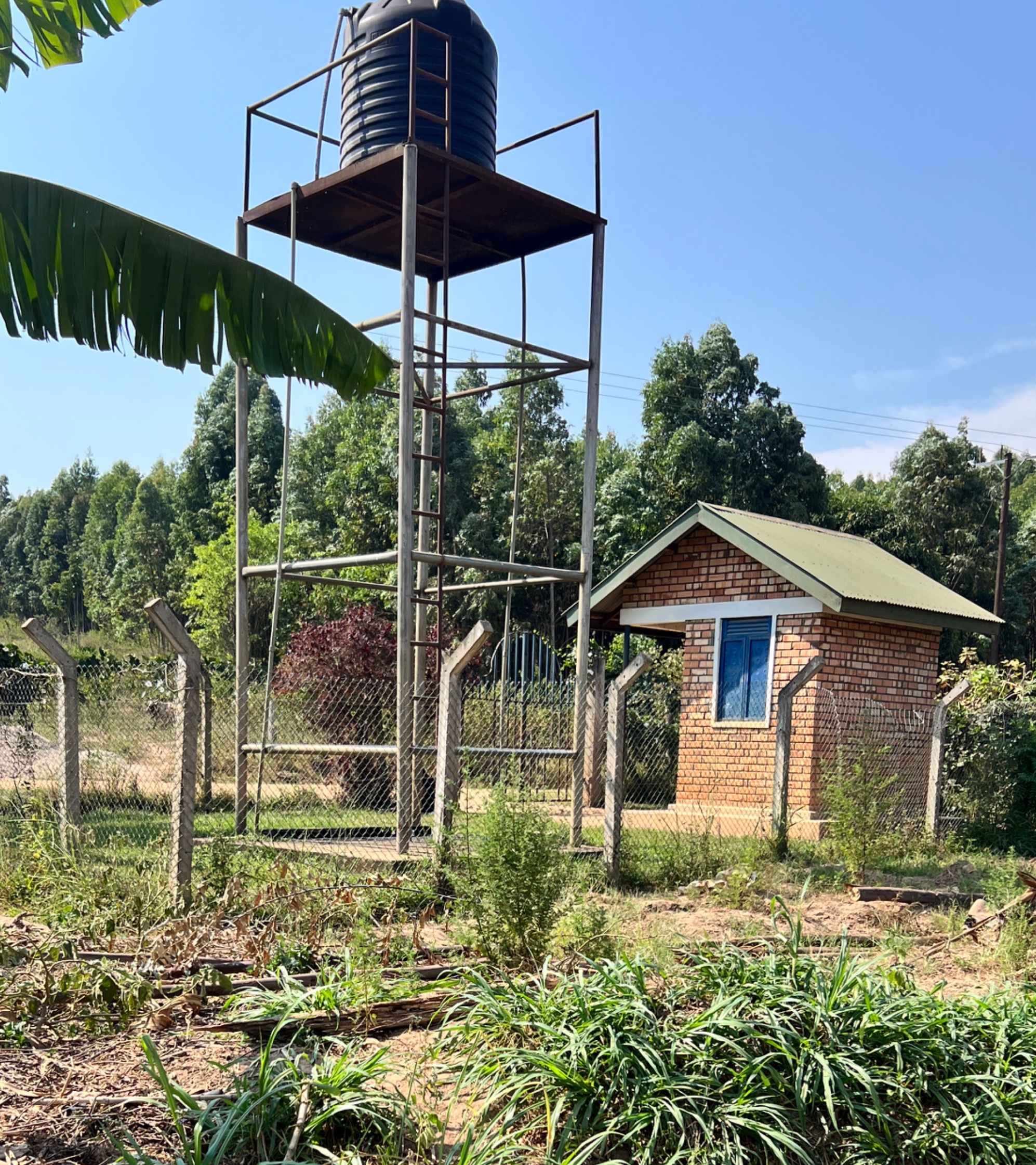An elevated water tank with a small building nearby
