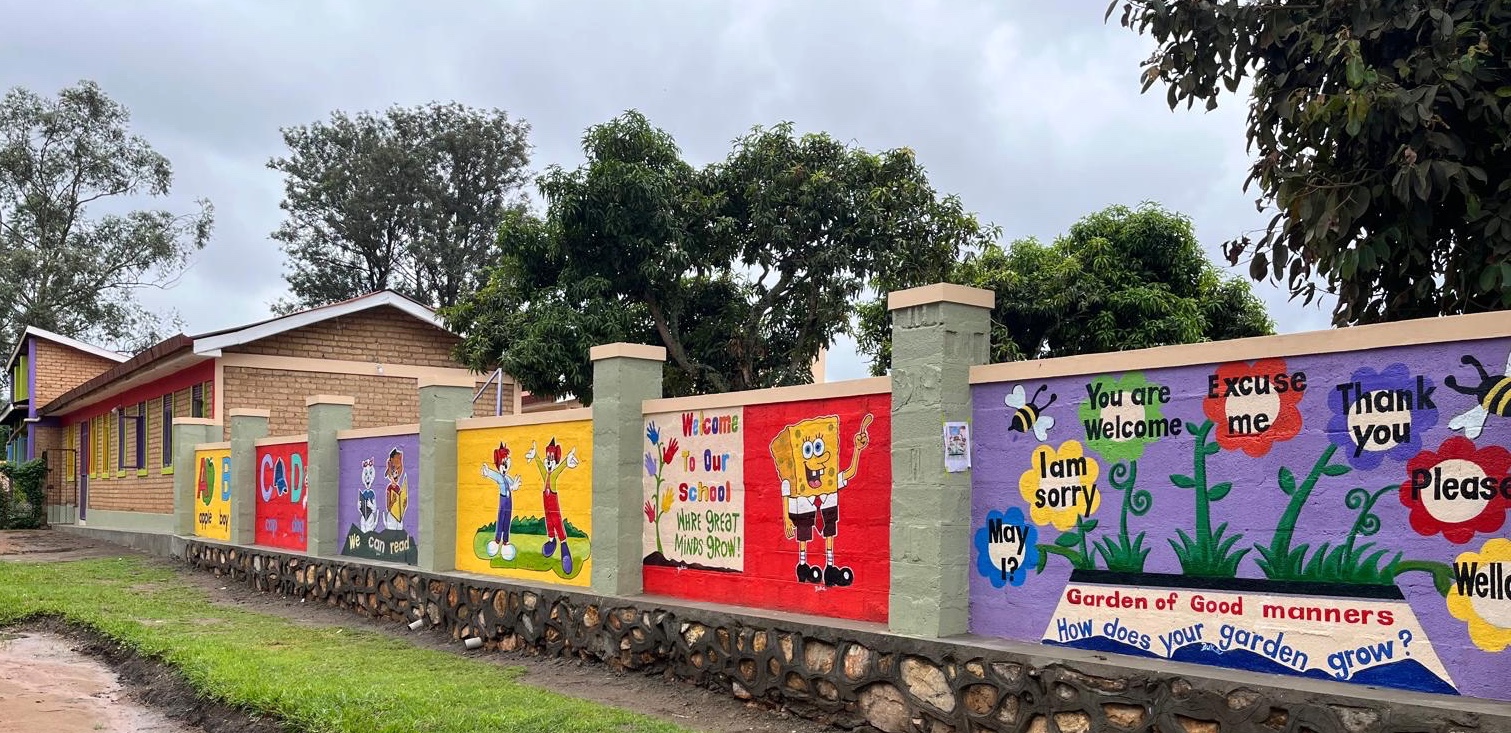 A colorful nursery school wall with cartoon characters and messages of early learning