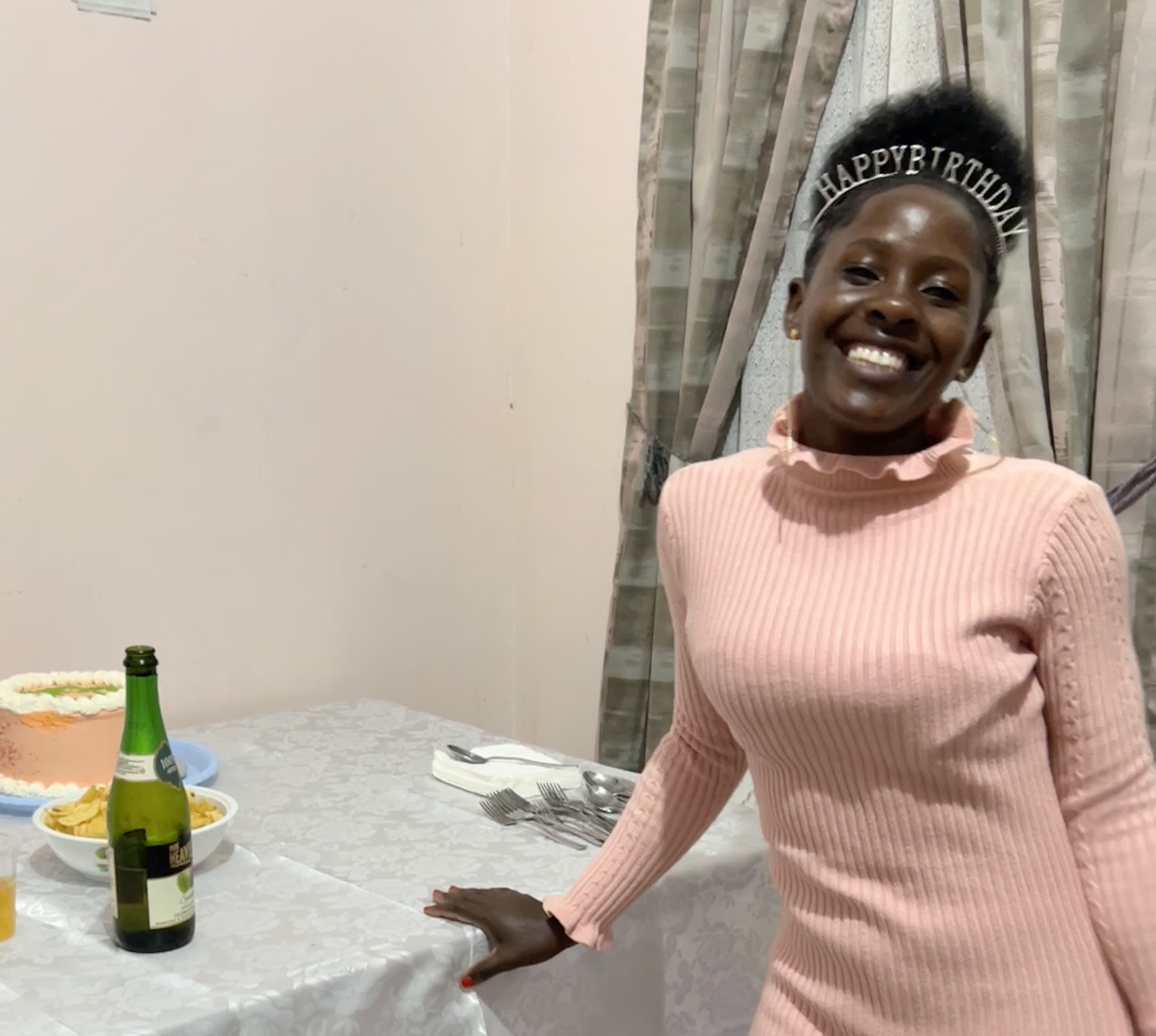 Ugandan young woman with a Happy Birthday tiara 