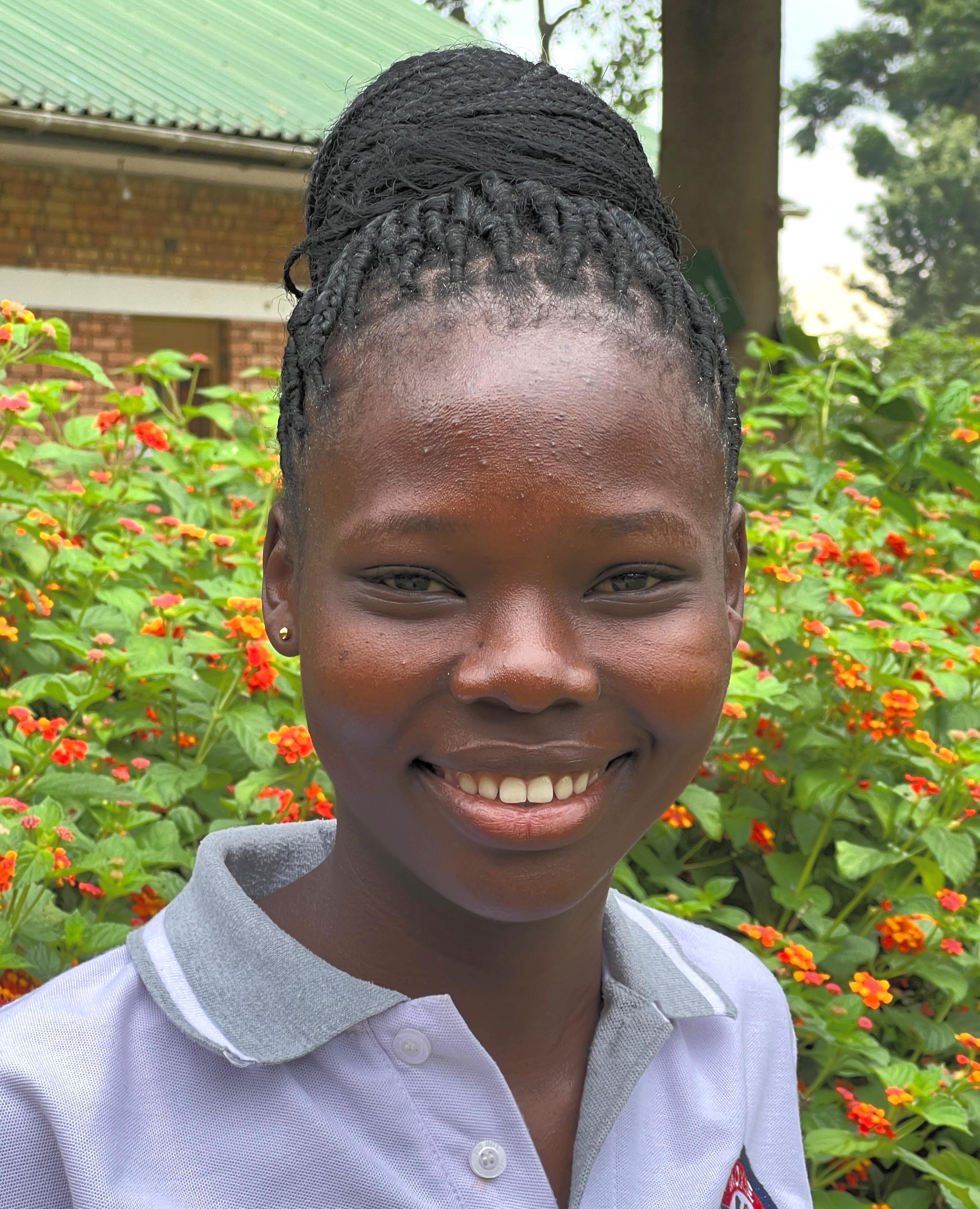 Smiling, well-groomed, young Ugandan woman