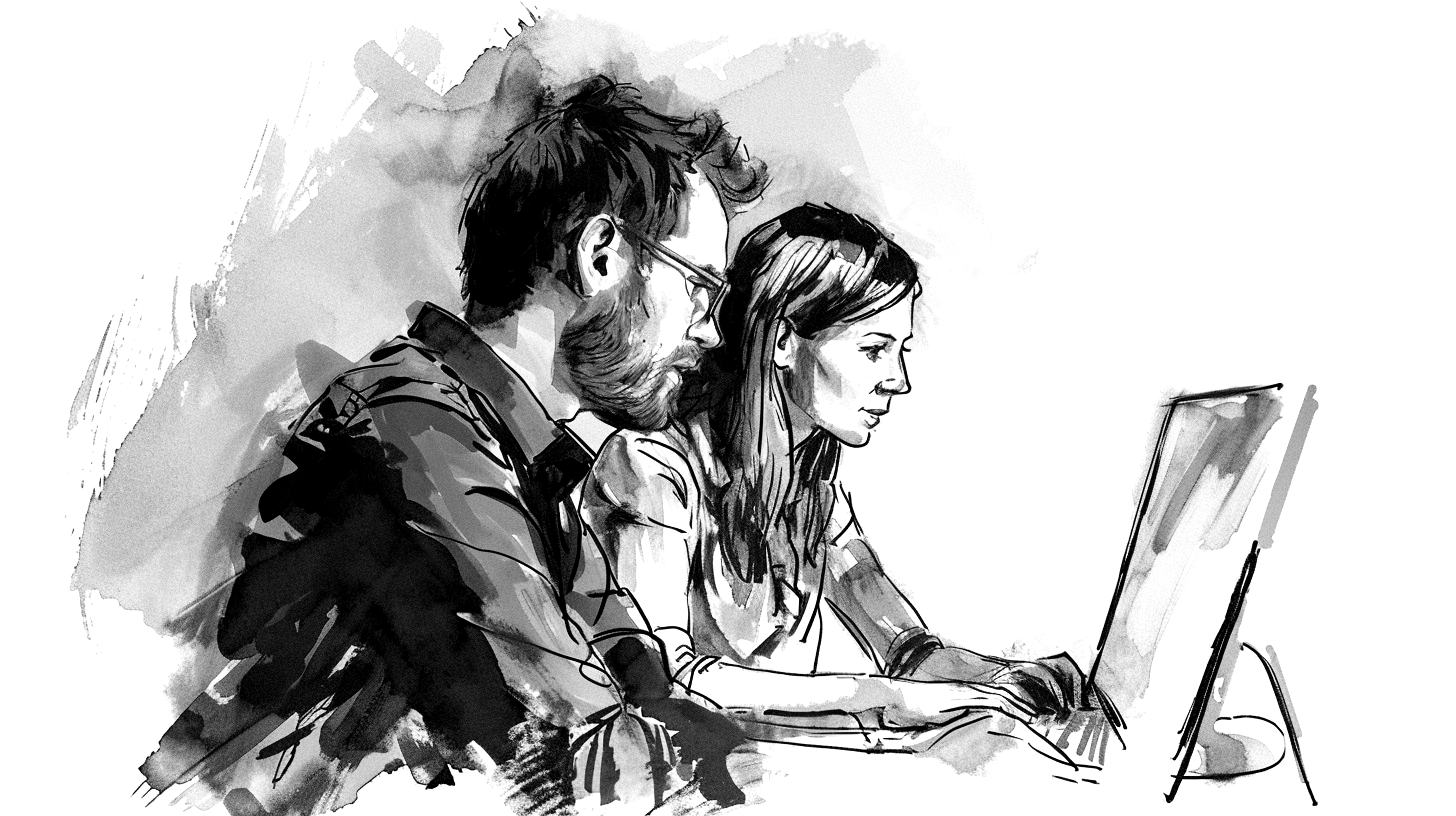 Un homme aide une femme à utiliser un logiciel