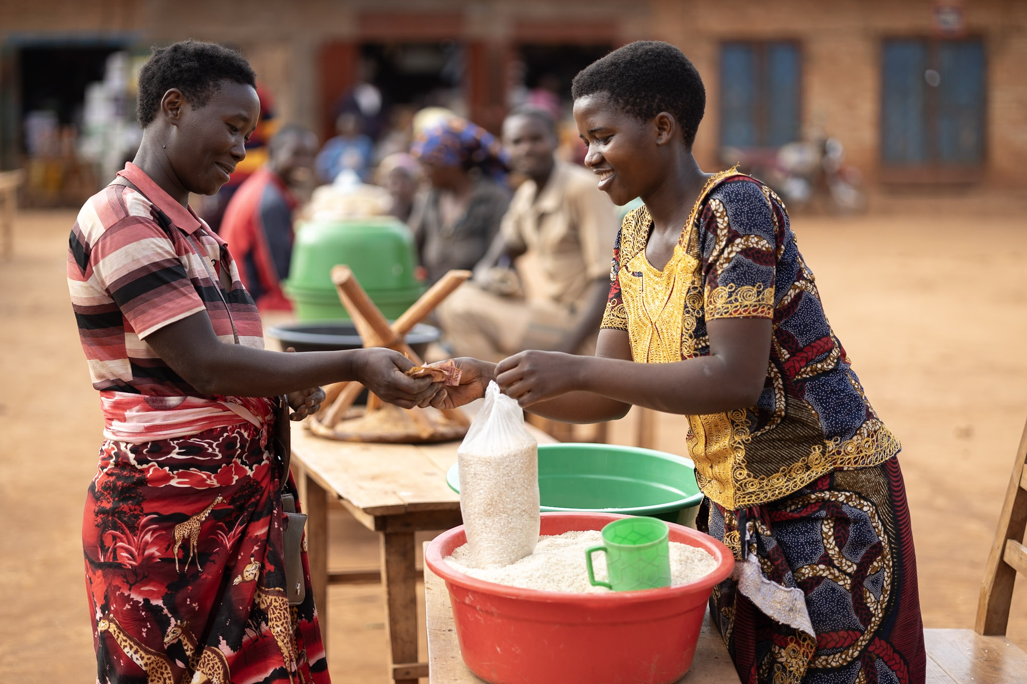 A Savings Group member in Burundi selling a bag of rice
