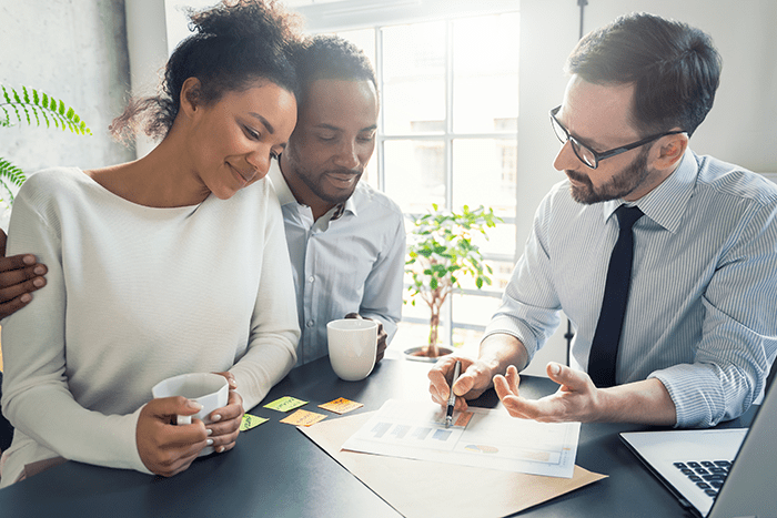 Couple speaking with mortgage broker